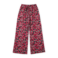 Black palazzo pants with a bold red bloom print and front tie waist