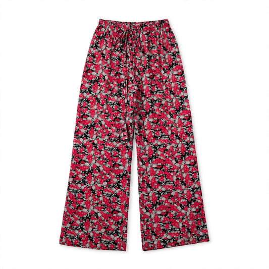 Black palazzo pants with a bold red bloom print and front tie waist