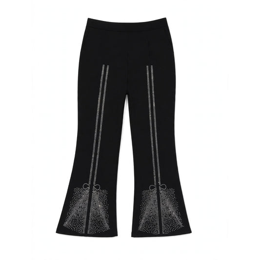Girls' black flared pants with rhinestone bow detail across the flared hem